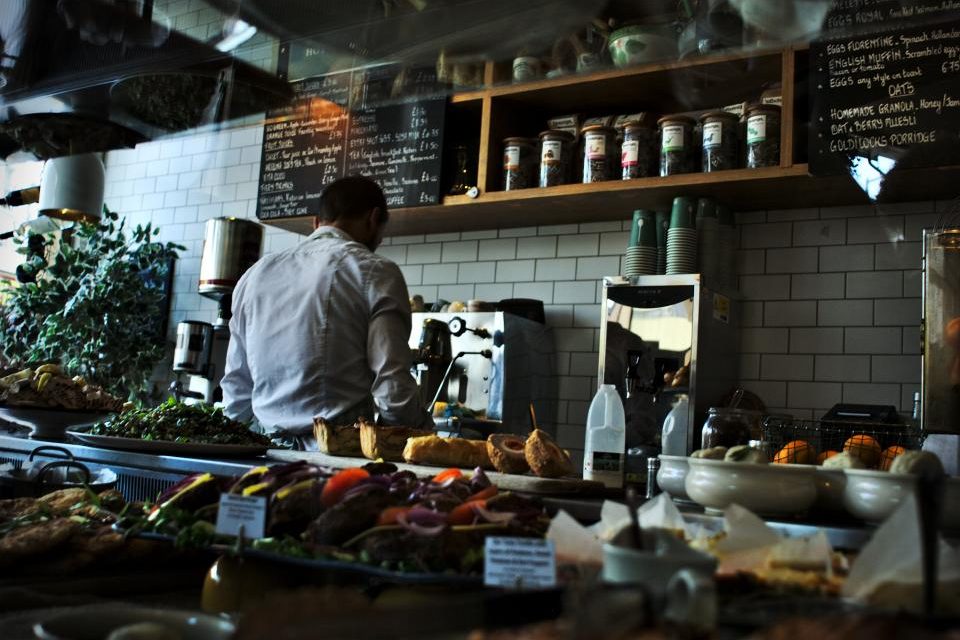 A chef plating in an open restaurant kitchen