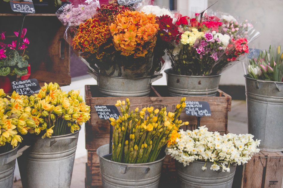 Buckets of fresh flowers outside a florist