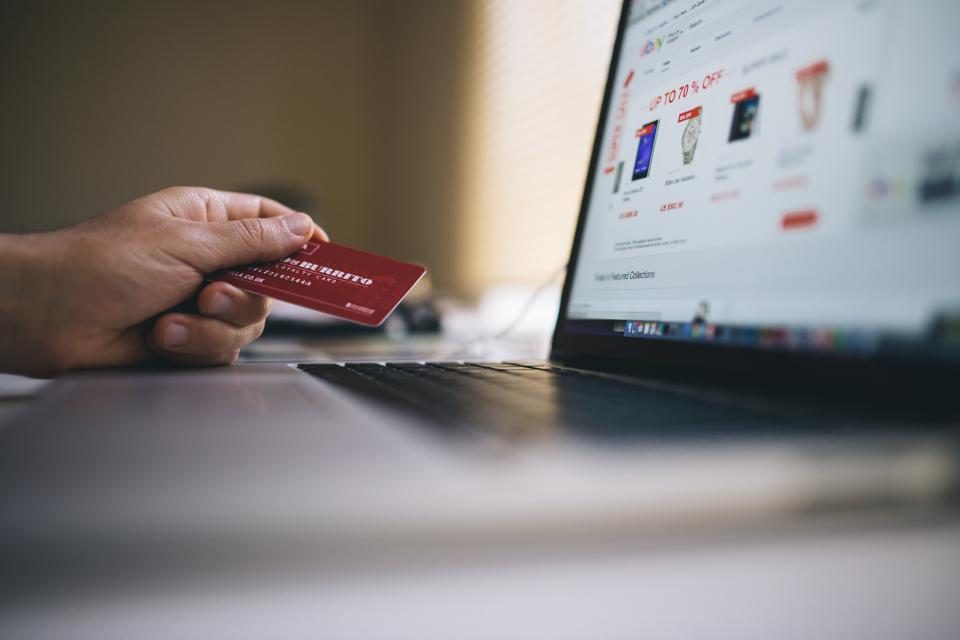 A shopper entering card details on a laptop