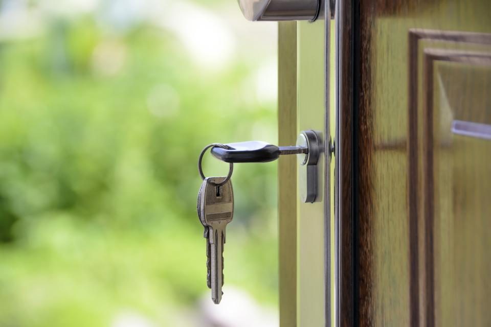 A house key hanging in an open front door